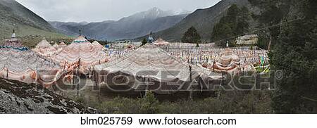 Traditional Buddhist prayer flags in a large group on the valley floor View Large Photo Image Stock Photo - Traditional Buddhist prayer flags in a large group on the valley floor. Fotosearch