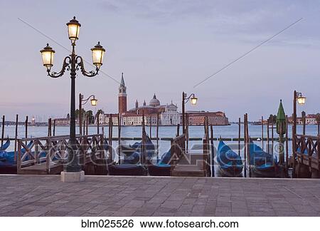 Traditional gondolas moored along the waterfront in Venice View Large Photo Image Stock Photograph - Traditional gondolas moored along the waterfront in Venice. Fotosearch