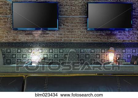 TVs on brick wall in restaurant View Large Photo Image Picture - TVs on brick wall in restaurant. Fotosearch