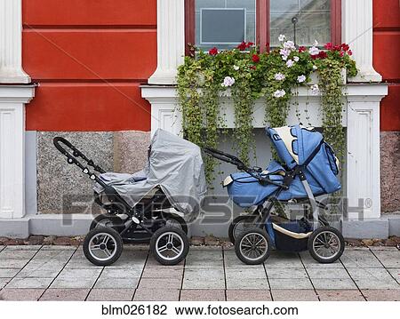 Two prams outside a house, under a window box View Large Photo Image Stock Image - Two prams outside a house, under a window box. Fotosearch