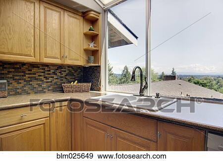 View out of the large window by the sink View Large Photo Image Stock Photo - View out of the large window by the sink. Fotosearch