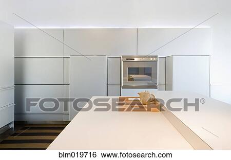 Stock Photograph - White Counters and Dining Area. Fotosearch
