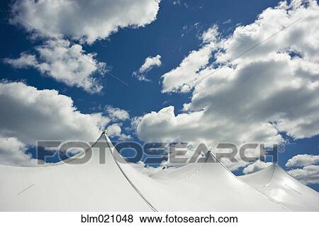 White Tent Top Against a Cloudy Sky View Large Photo Image Stock Photo - White Tent Top Against a Cloudy Sky. Fotosearch