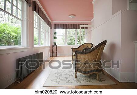 Stock Image - Wicker Chairs in a Sun Room. Fotosearch