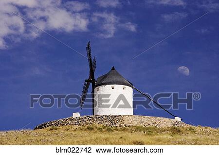 Stock Image - Windmill on Hilltop with Gibbous Moon. Fotosearch