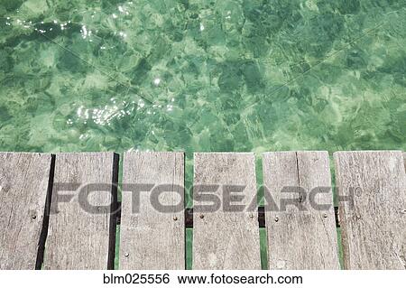 Wooden pier over shallow turquoise blue water at Cancun View Large Photo Image Stock Photograph - Wooden pier over shallow turquoise blue water at Cancun. Fotosearch