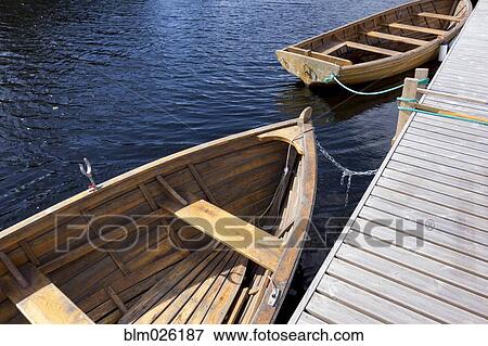 Wooden rowing boats moored View Large Photo Image Stock Photo - Wooden rowing boats moored . Fotosearch