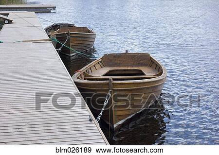 Wooden rowing boats moored View Large Photo Image Stock Photo - Wooden rowing boats moored . Fotosearch