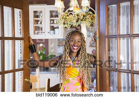 Stock Photograph - African American woman standing in doorway. Fotosearch