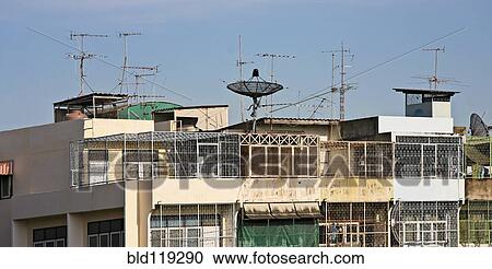 Stock Image - Apartment building with satellite dish. Fotosearch