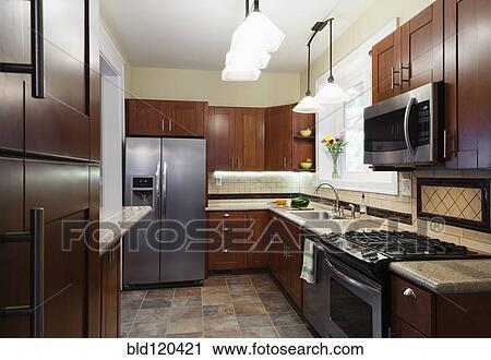 Stock Image - Appliances and cabinets in kitchen. Fotosearch