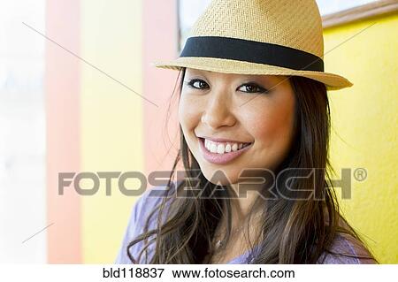 Stock Photo - Asian woman smiling outdoors. Fotosearch
