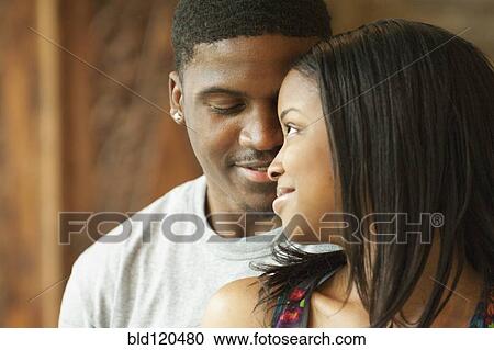Stock Image - Black couple relaxing together. Fotosearch