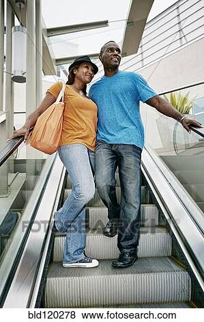 Black couple riding escalator together View Large Photo Image Stock Photo - Black couple riding escalator together. Fotosearch