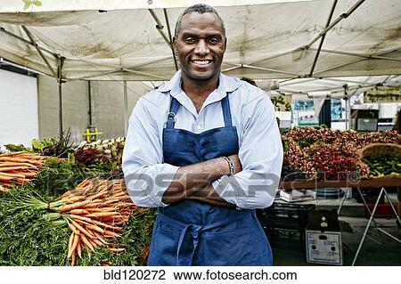 Black man working at outdoor market View Large Photo Image Stock Image - Black man working at outdoor market. Fotosearch