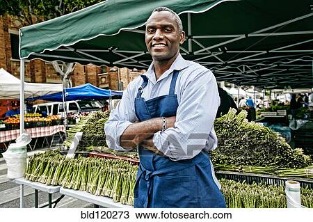 Black man working at outdoor market View Large Photo Image Stock Image - Black man working at outdoor market. Fotosearch