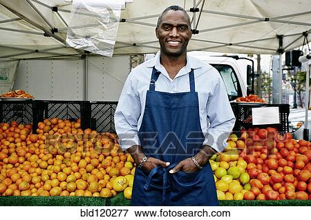 Black man working at outdoor market View Large Photo Image Stock Photo - Black man working at outdoor market. Fotosearch