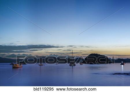 Stock Photography - Boats sailing in bay at dawn, Bay of Islands, New Zealand. Fotosearch
