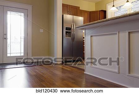 Stock Image - Breakfast bar and refrigerator in kitchen. Fotosearch