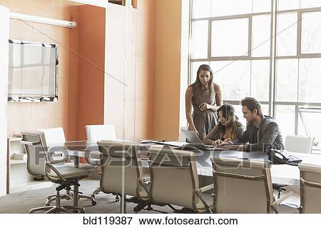 Stock Photo - Business people talking in meeting. Fotosearch