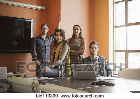 Stock Image - Businesspeople smiling in meeting. Fotosearch