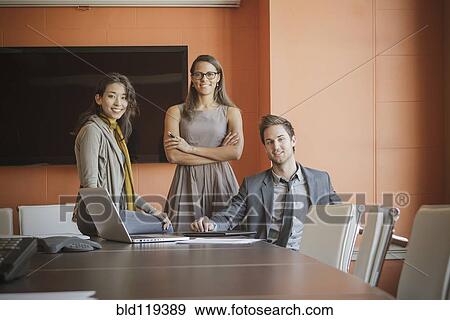 Stock Photo - Businesspeople smiling in meeting. Fotosearch