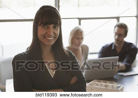 Stock Image - Businesswoman smiling in meeting. Fotosearch