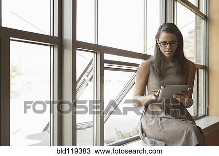 Stock Image - Businesswoman using tablet computer. Fotosearch