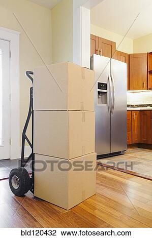 Stock Image - Cardboard boxes in new house. Fotosearch