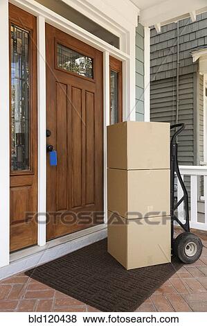 Stock Photo - Cardboard boxes on front porch of house. Fotosearch