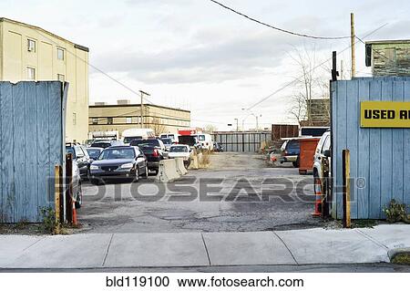 Stock Image - Cars parked in urban lot. Fotosearch