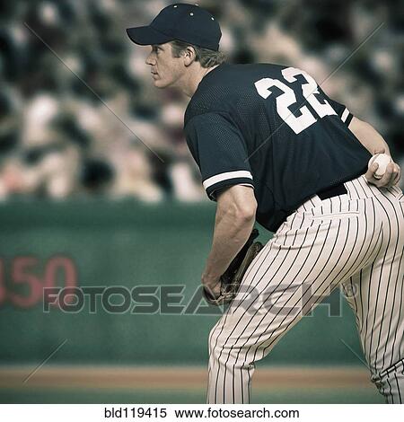 Stock Photography - Caucasian baseball player ready to throw ball. Fotosearch