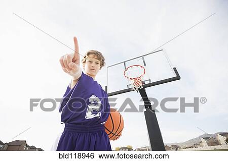 Caucasian basketball player holding out finger on court View Large Photo Image Stock Photograph - Caucasian basketball player holding out finger on court. Fotosearch