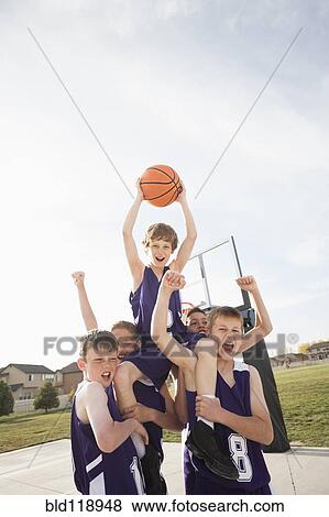 Caucasian basketball team cheering on court View Large Photo Image Stock Photo - Caucasian basketball team cheering on court. Fotosearch