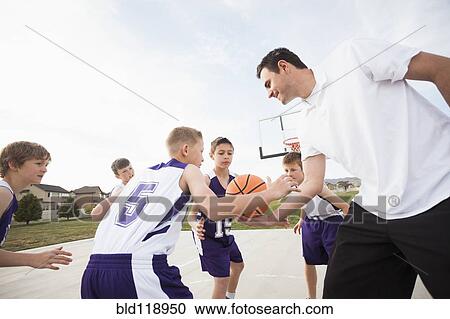 Caucasian basketball team playing on court View Large Photo Image Stock Image - Caucasian basketball team playing on court. Fotosearch