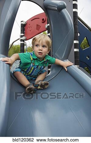 Caucasian boy playing on slide View Large Photo Image Stock Image - Caucasian boy playing on slide. Fotosearch