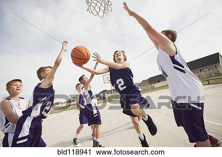 Caucasian boys playing basketball on court View Large Photo Image Stock Image - Caucasian boys playing basketball on court. Fotosearch