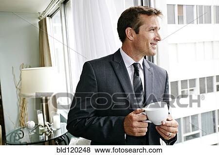 Stock Photo - Caucasian businessman having cup of coffee. Fotosearch