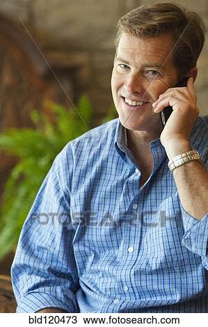 Stock Image - Caucasian businessman talking on cell phone. Fotosearch