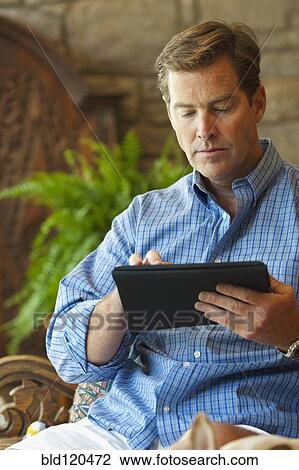 Caucasian businessman using digital tablet View Large Photo Image Stock Image - Caucasian businessman using digital tablet. Fotosearch
