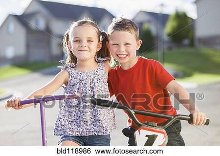 Stock Photograph - Caucasian children smiling outdoors. Fotosearch