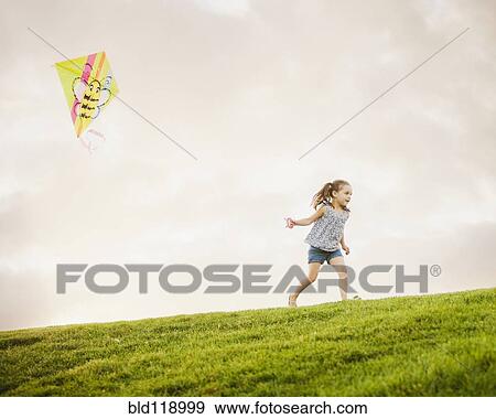 Caucasian girl flying kite View Large Photo Image Stock Photo - Caucasian girl flying kite. Fotosearch