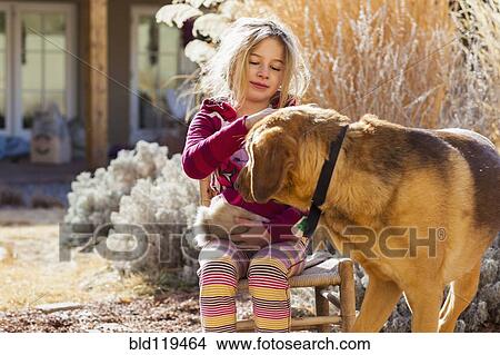 Caucasian girl petting dog outdoors View Large Photo Image Picture - Caucasian girl petting dog outdoors. Fotosearch