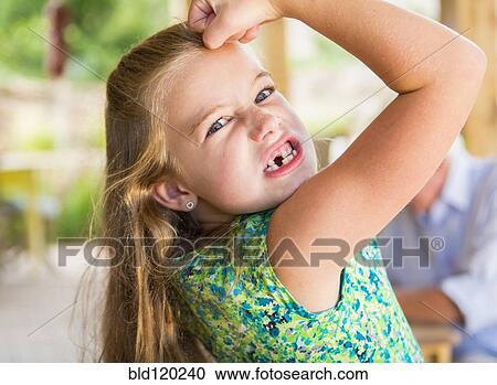 Caucasian girl showing missing teeth and flexing biceps View Large Photo Image Stock Image - Caucasian girl showing missing teeth and flexing biceps. Fotosearch