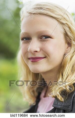 Picture - Caucasian girl smiling outdoors. Fotosearch
