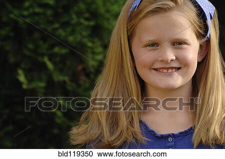 Stock Image - Caucasian girl smiling outdoors. Fotosearch