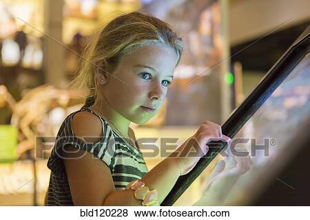 Stock Photo - Caucasian girl using touch screen. Fotosearch