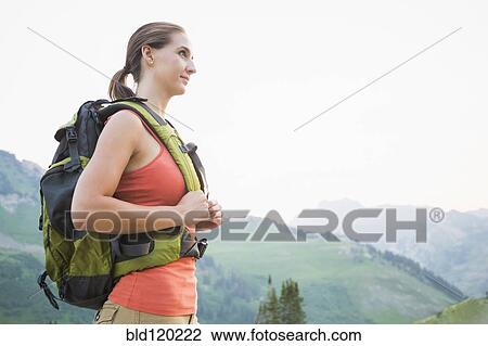 Stock Image - Caucasian hiker wearing backpack. Fotosearch