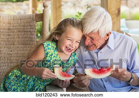 Caucasian man and granddaughter eating watermelon View Large Photo Image Stock Image - Caucasian man and granddaughter eating watermelon. Fotosearch