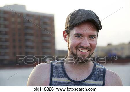 Stock Photograph - Caucasian man smiling on beach. Fotosearch